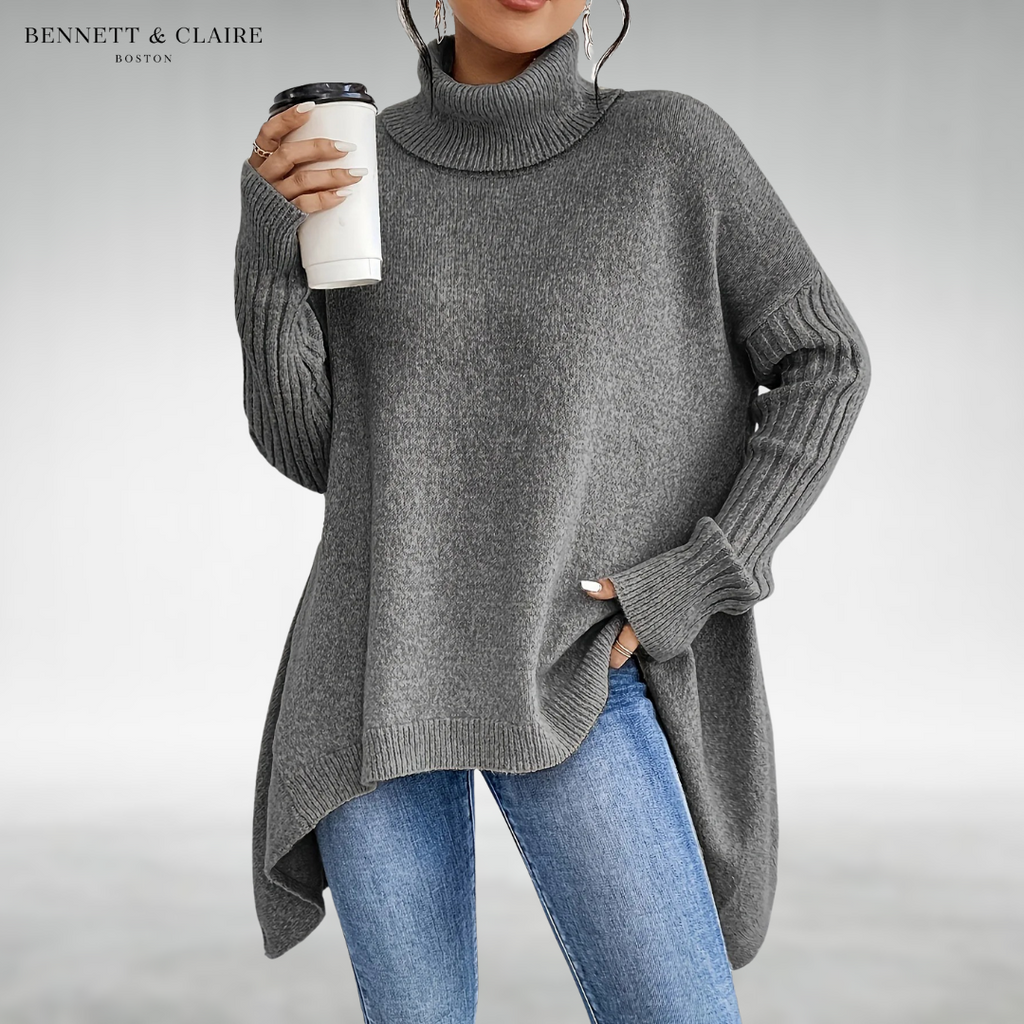Women's oversized turtleneck knit tunic sweater with long sleeves and an asymmetric hem