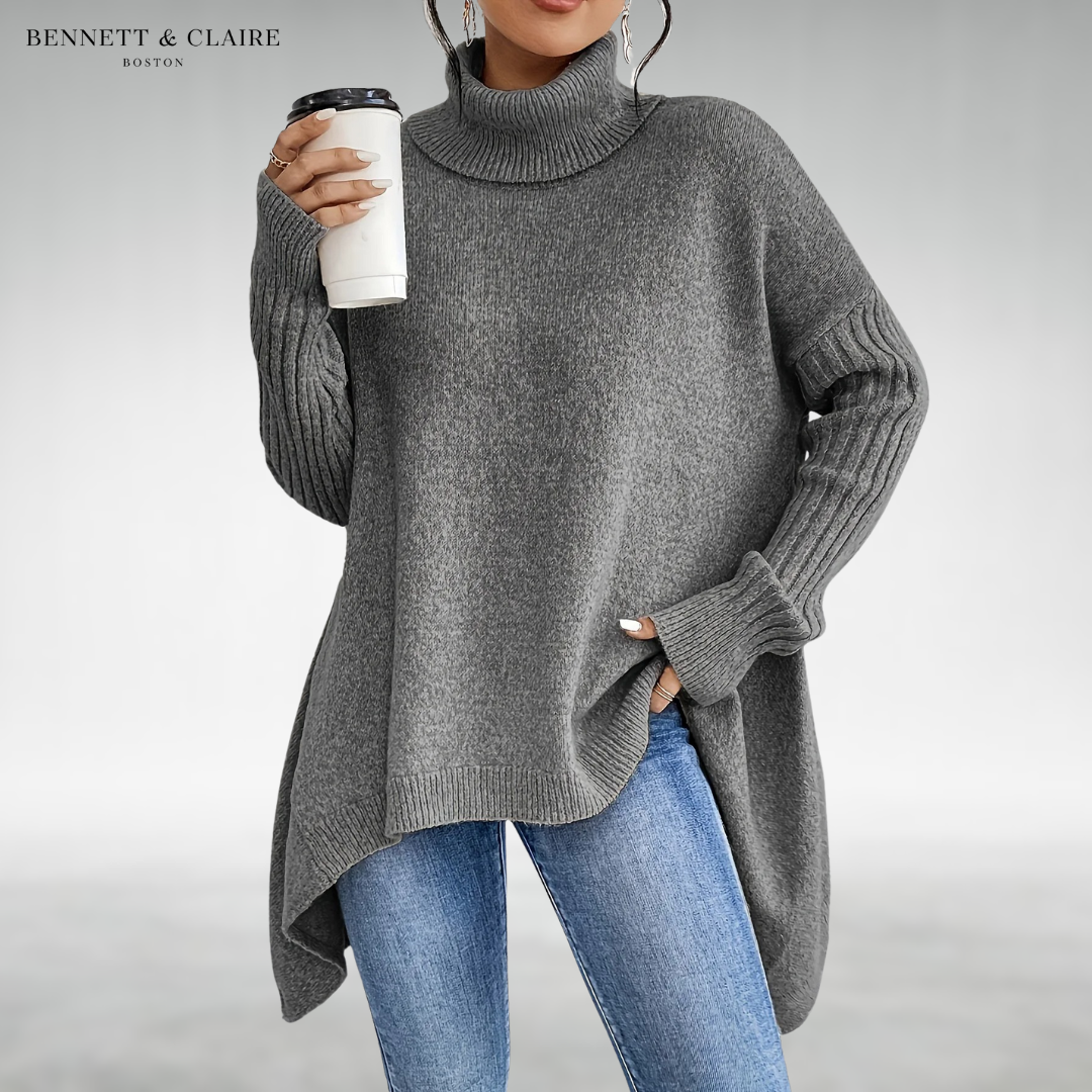 Women's oversized turtleneck knit tunic sweater with long sleeves and an asymmetric hem