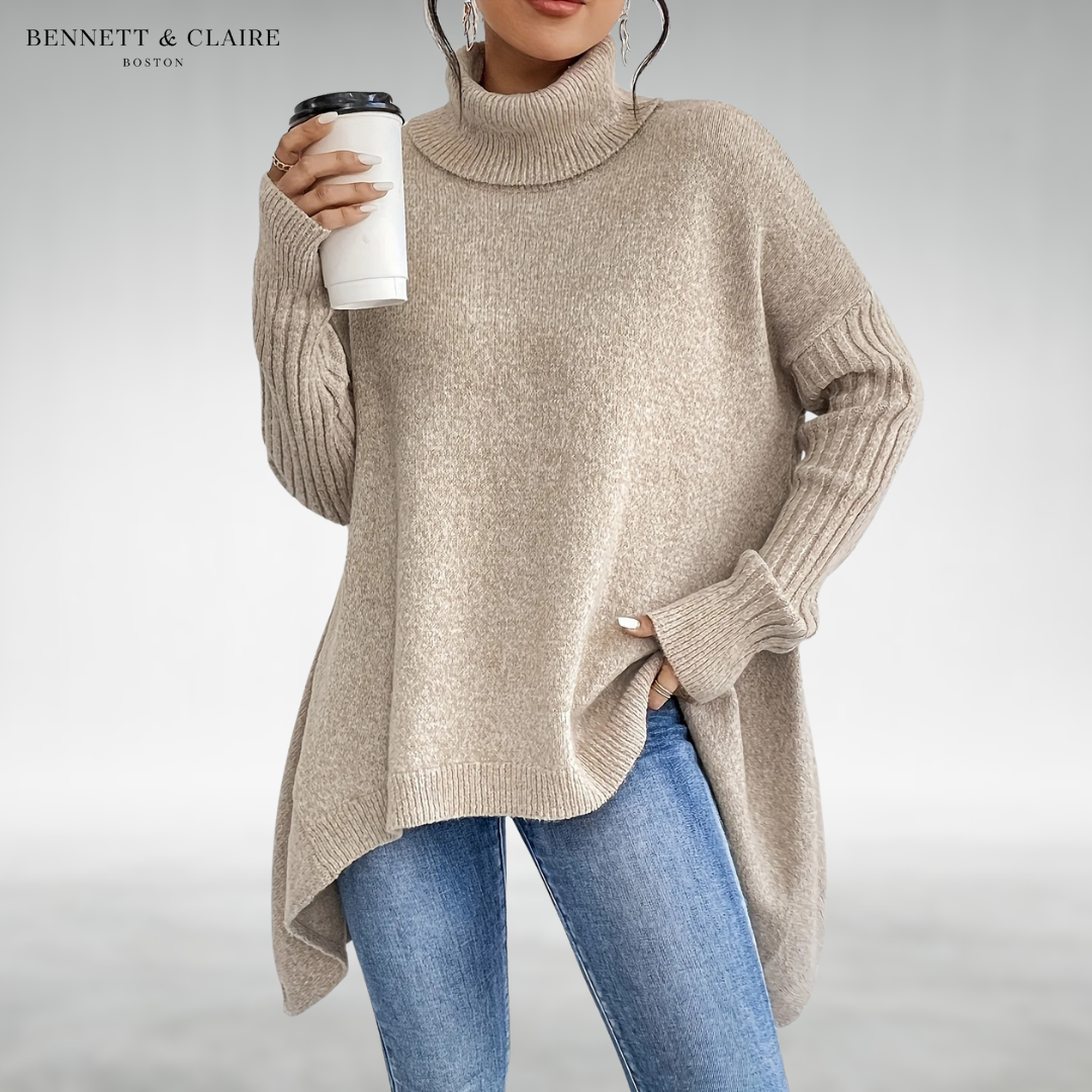 Women's oversized turtleneck knit tunic sweater with long sleeves and an asymmetric hem