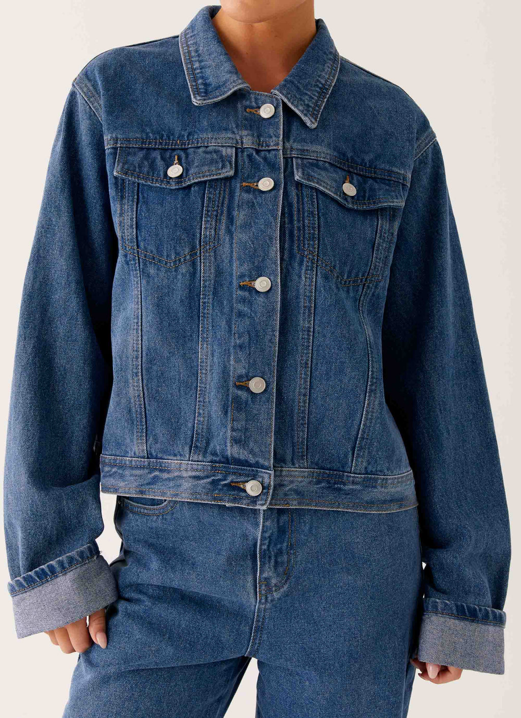 Women's oversized blue denim jacket with collar, long sleeves and front pockets