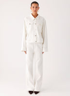 Women's oversized white denim jacket with collar and buttoned chest pockets