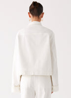 Women's oversized white denim jacket with collar and buttoned chest pockets