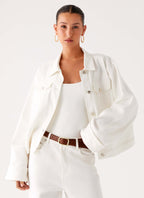 Women's oversized white denim jacket with collar and buttoned chest pockets