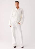 Women's oversized white denim jacket with collar and buttoned chest pockets