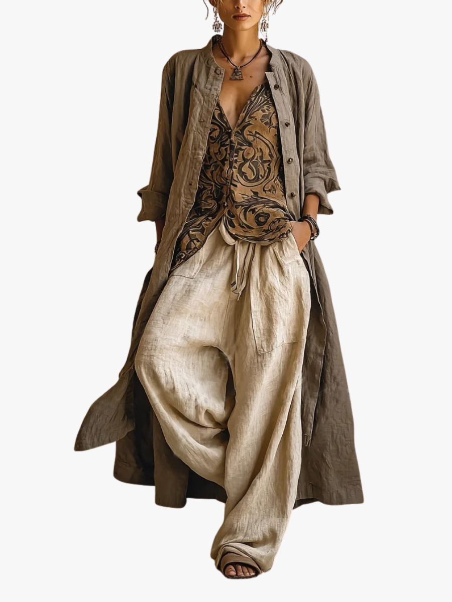 Woman wearing three-piece set with taupe button shirt, patterned scrollwork vest and cream wide-leg trousers