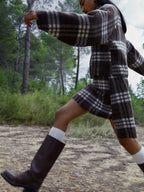 Women's brown plaid mini skirt with high waist and fringed hem