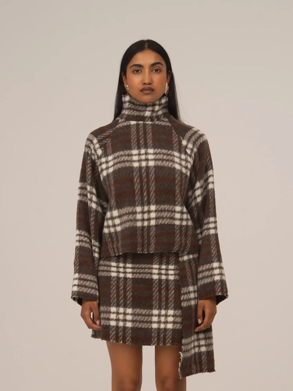 Women's brown plaid cropped turtleneck top with long sleeves and fringed edges