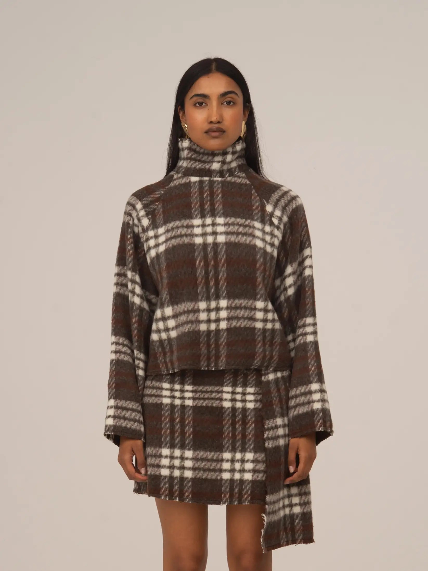 Women's brown plaid cropped turtleneck top with long sleeves and fringed edges