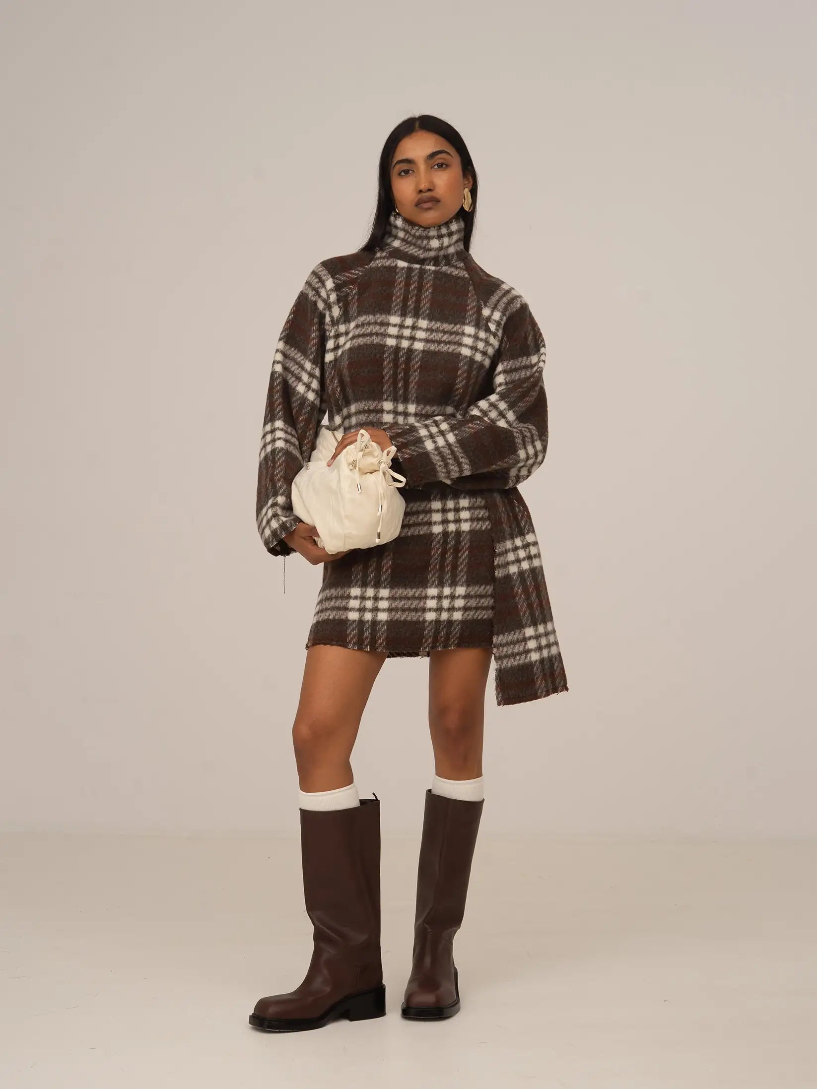 Women's brown plaid cropped turtleneck top with long sleeves and fringed edges