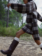Women's brown plaid cropped turtleneck top with long sleeves and fringed edges