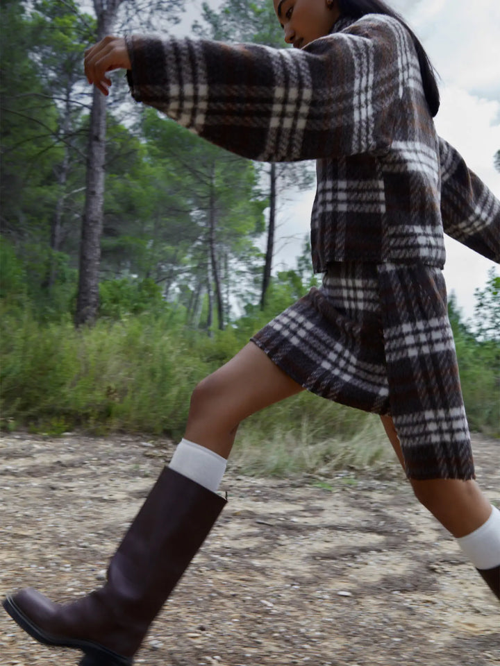 Women's brown plaid cropped turtleneck top with long sleeves and fringed edges