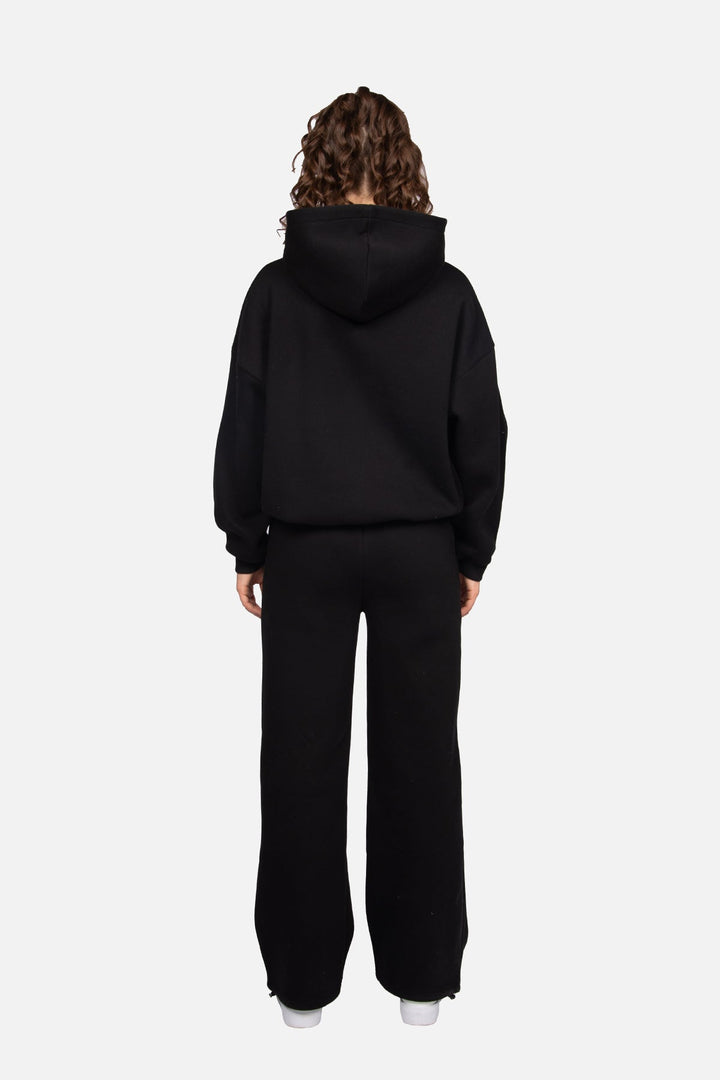 Women's black cropped hoodie with pink chest logo