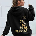 Women's oversized hooded sweatshirt with contrasting text graphic on the back