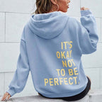 Women's oversized hooded sweatshirt with contrasting text graphic on the back