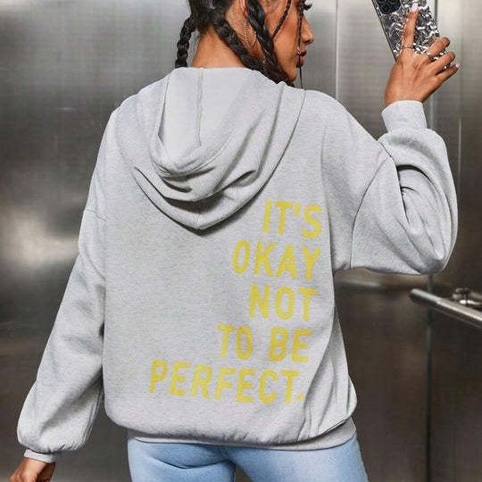 Women's oversized hooded sweatshirt with contrasting text graphic on the back