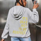 Women's oversized hooded sweatshirt with contrasting text graphic on the back