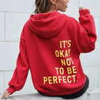 Women's oversized hooded sweatshirt with contrasting text graphic on the back