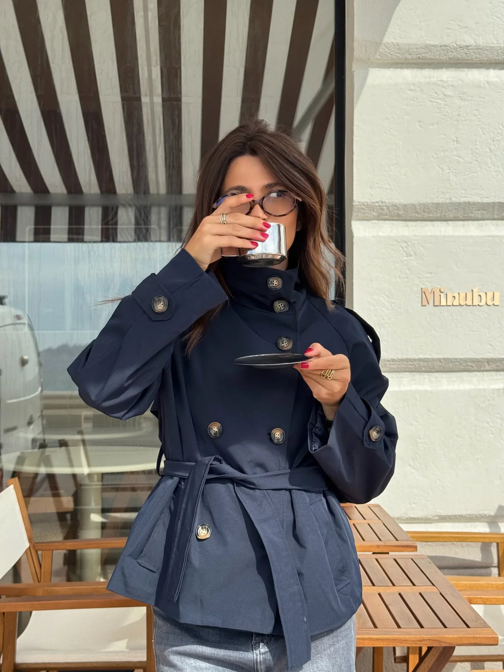 Women's navy short belted jacket with high collar, buttons and flap pockets