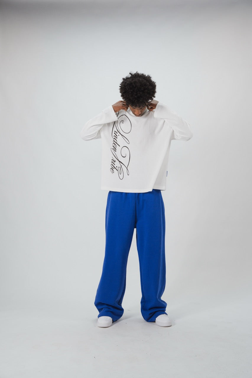 White waffle sweatshirt with black script graphic and long sleeves