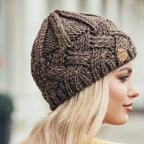 Women's chunky cable knit beanie with folded cuff and side badge
