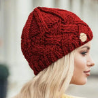 Women's chunky cable knit beanie with folded cuff and side badge