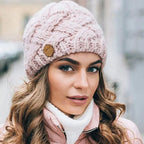 Women's chunky cable knit beanie with folded cuff and side badge