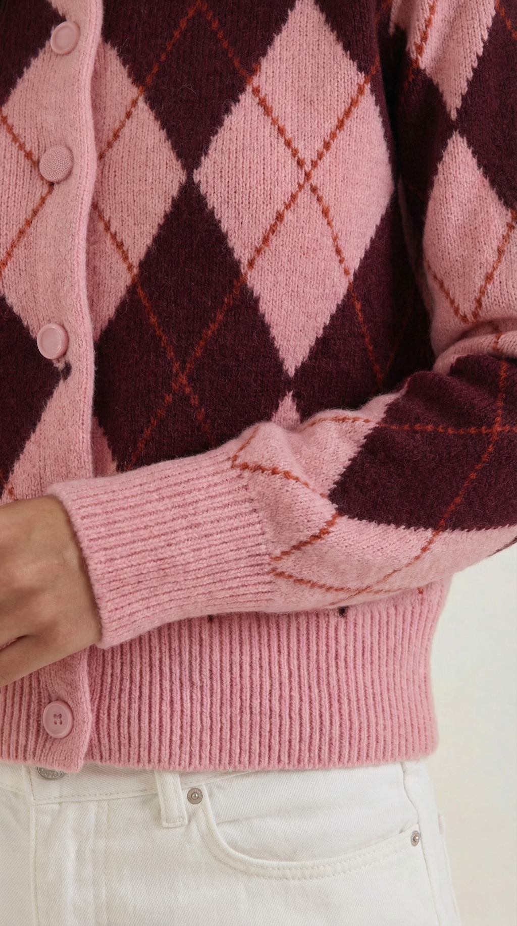 Women's pink argyle cardigan with long sleeves and button front