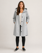 Women's hooded mid-length rain coat with button front and side pockets