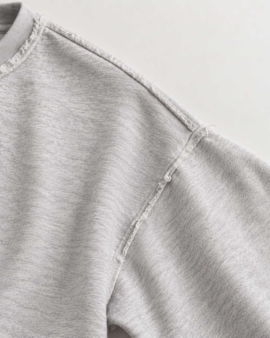 Grey cropped crew neck sweatshirt with long sleeves, distressed trims and USA sports graphic