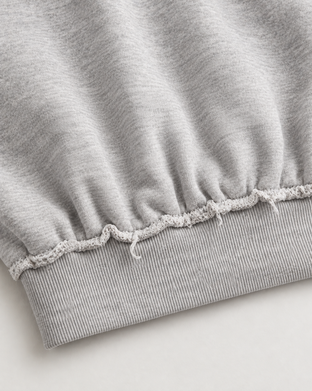 Grey cropped sweatshirt with distressed trims, long sleeves and cross flame graphic