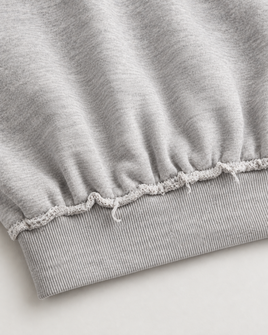 Grey cropped sweatshirt with distressed trims, long sleeves and cross flame graphic