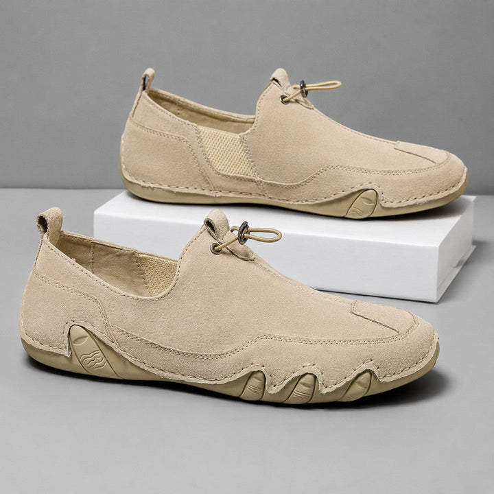 Men's slip-on moccasin loafers with toggle lace detail and flat segmented soles