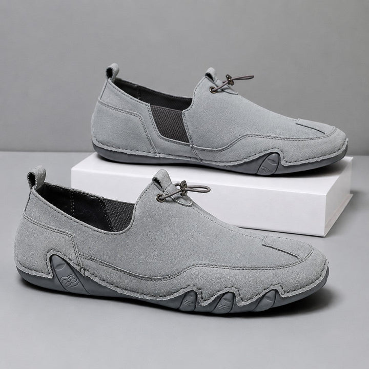 Men's slip-on moccasin loafers with toggle lace detail and flat segmented soles