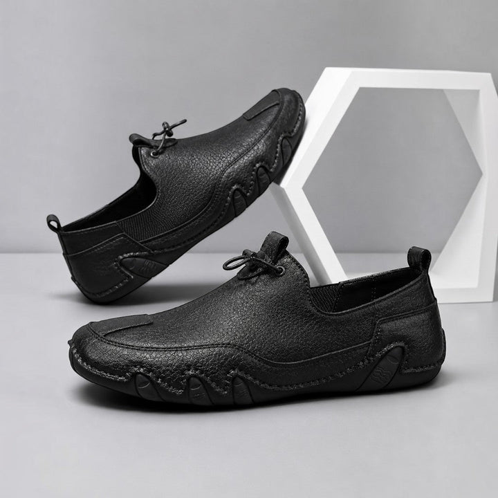 Men's slip-on moccasin loafers with toggle lace detail and flat segmented soles