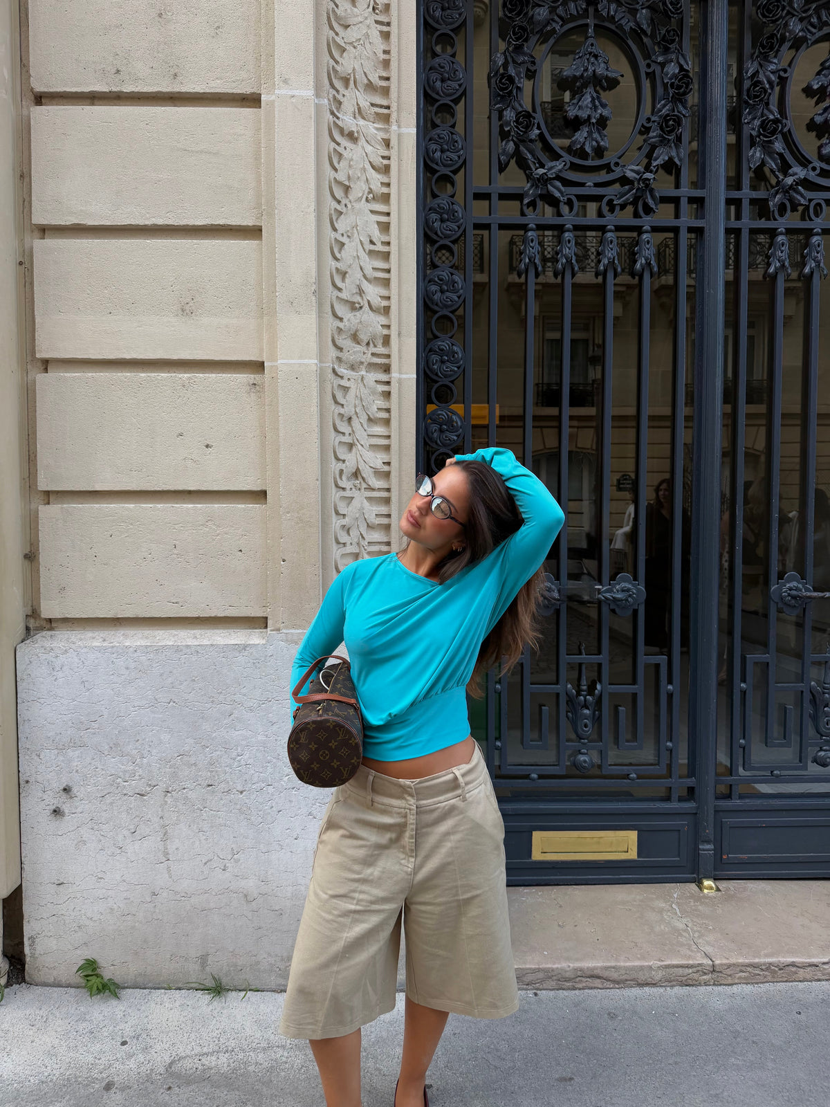 Women's blue asymmetric long sleeve top worn off one shoulder