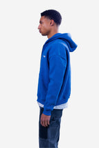 Men's blue zip-up hoodie with white chest text and front pouch pockets