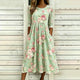 Green floral midi dress with round neck and three-quarter sleeves
