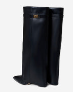 Women's black knee-high boots with pointed toes and buckle strap