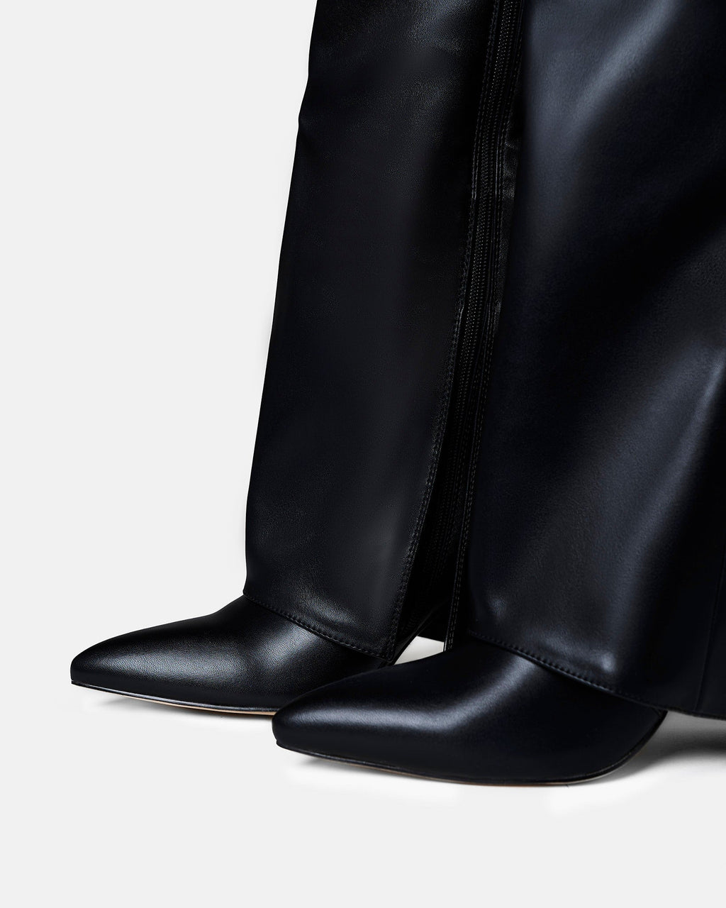 Women's black knee-high boots with pointed toes and buckle strap