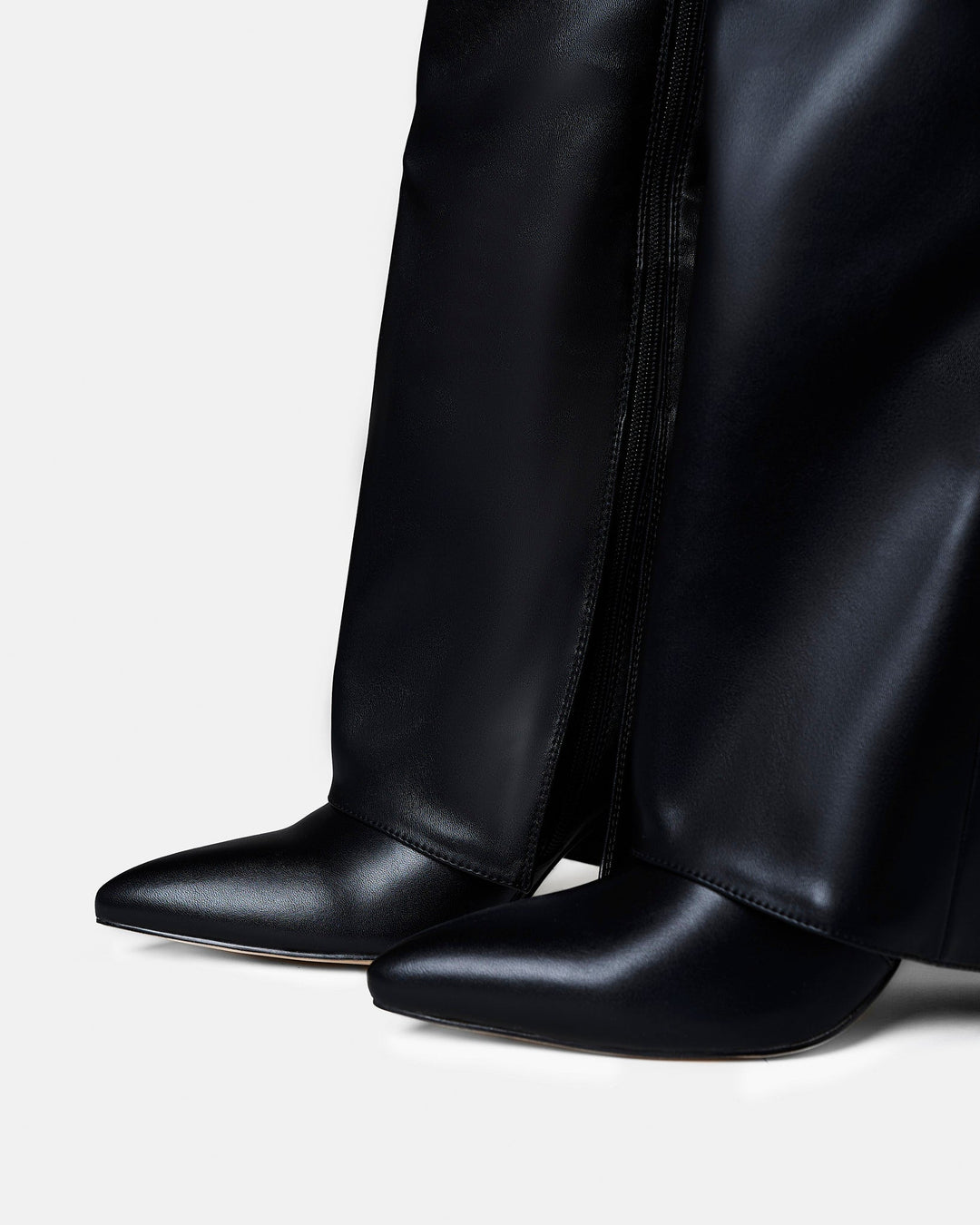 Women's black knee-high boots with pointed toes and buckle strap