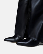 Women's black knee-high boots with pointed toes and buckle strap