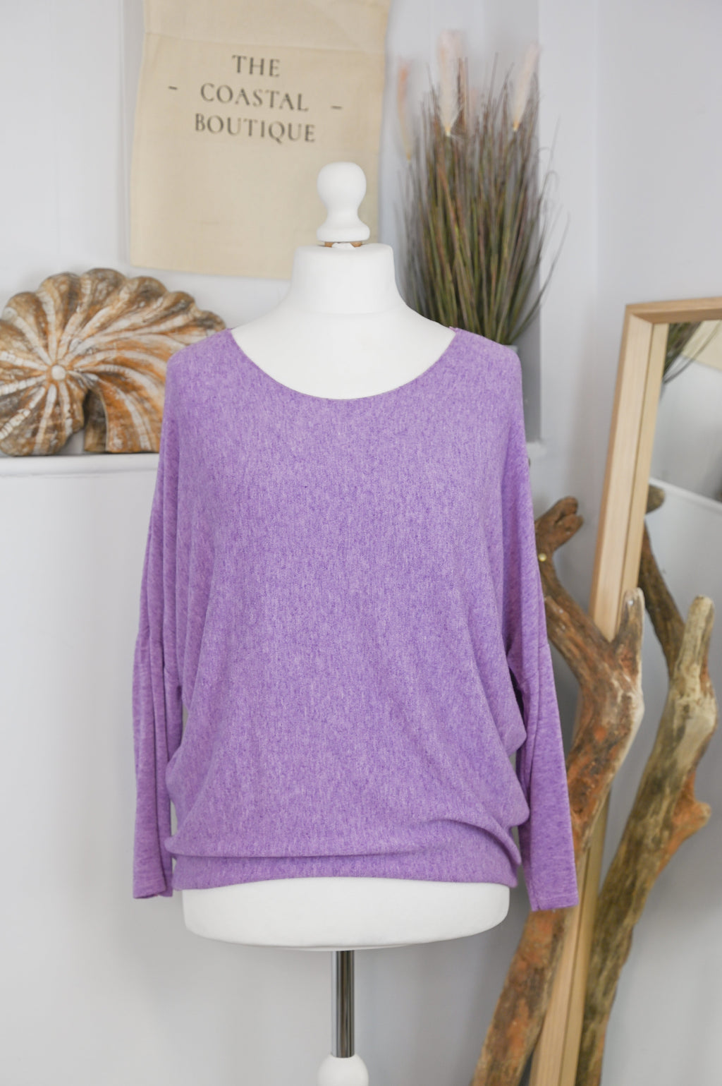 Women's long-sleeved round neck knitted jumper on a mannequin
