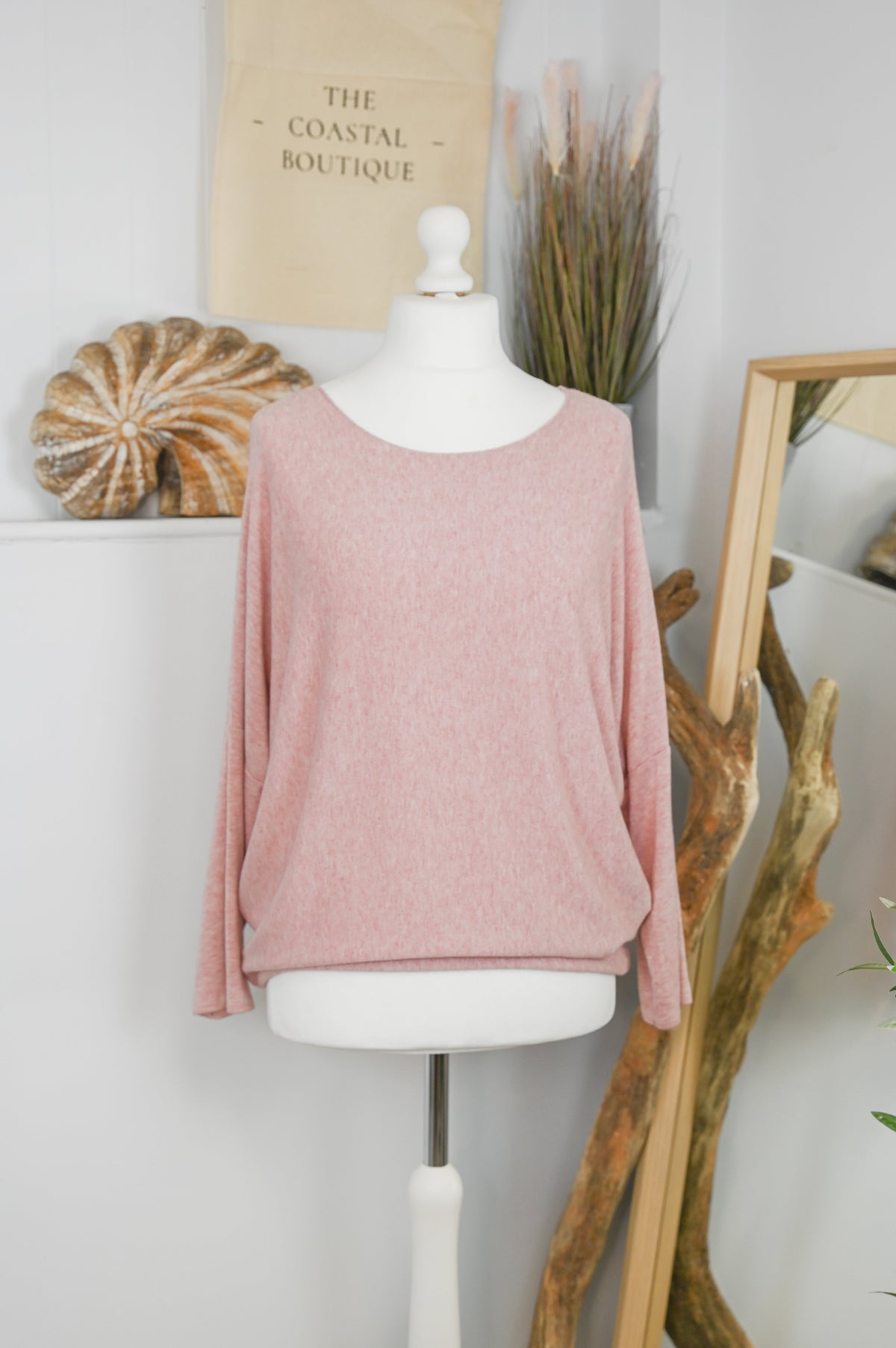 Women's long-sleeved round neck knitted jumper on a mannequin