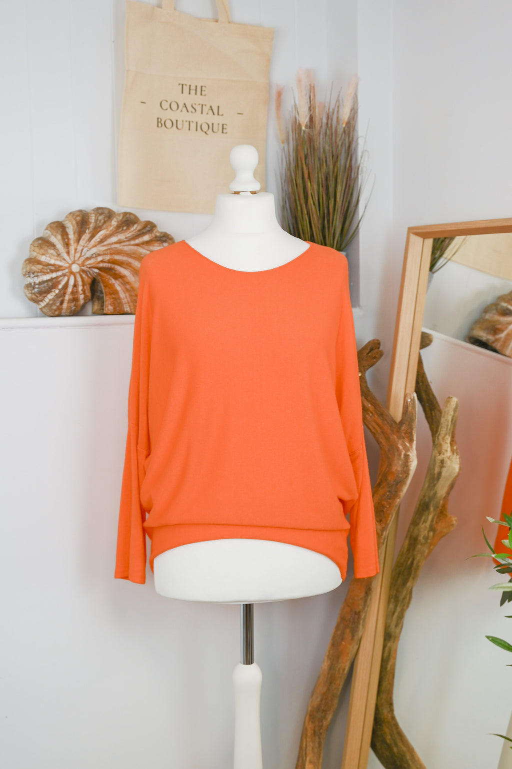 Women's long-sleeved round neck knitted jumper on a mannequin