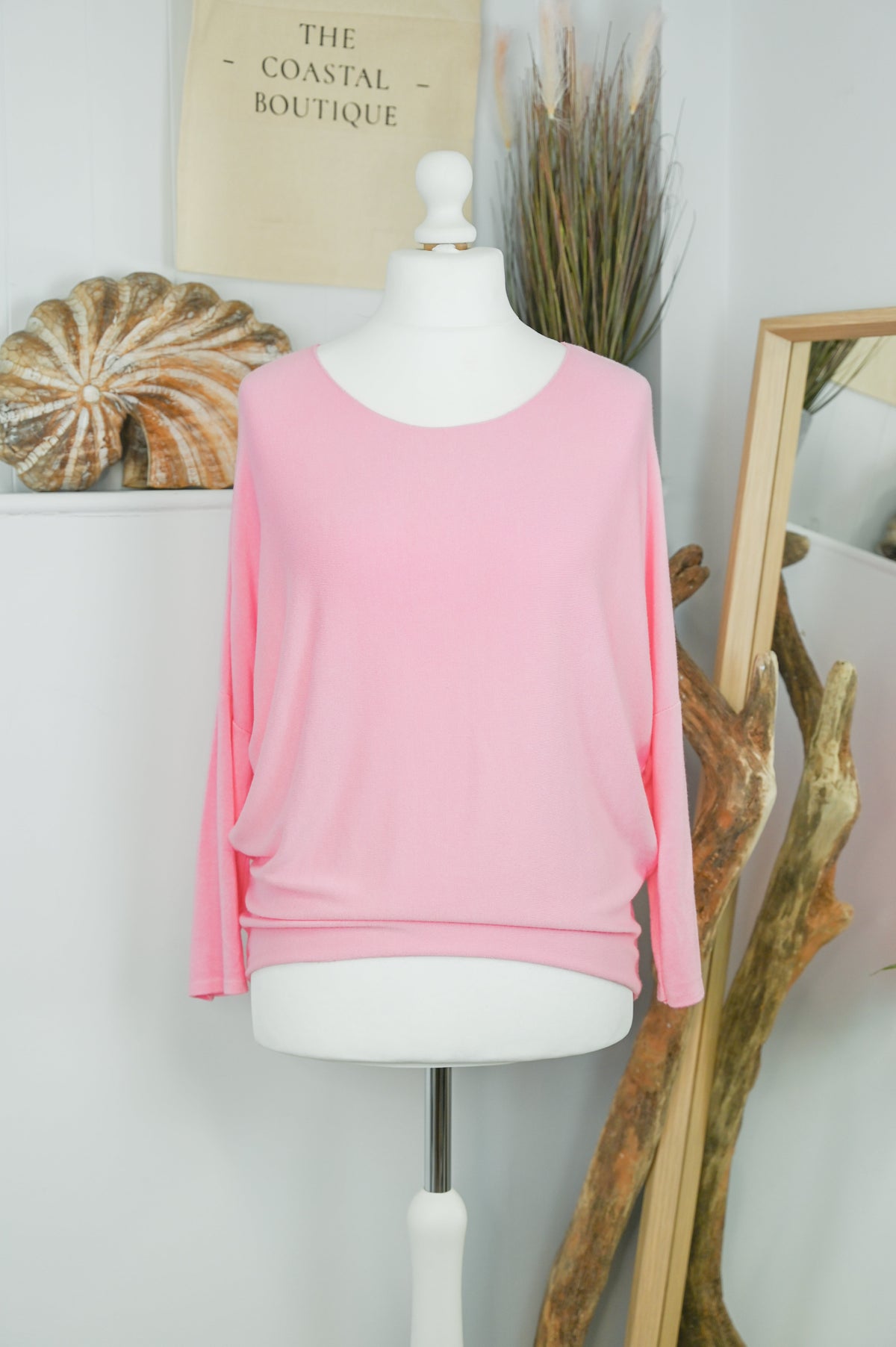 Women's long-sleeved round neck knitted jumper on a mannequin