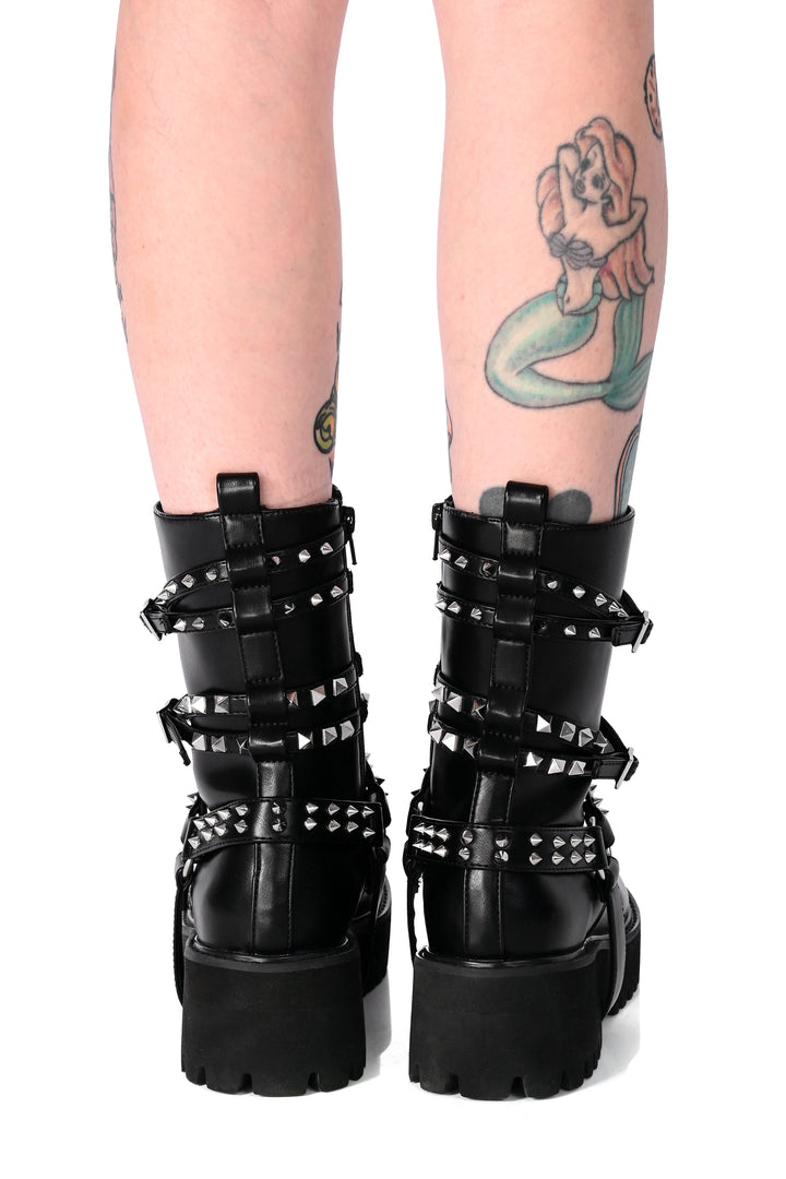 Women's black studded combat boots with buckled straps