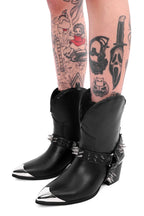 Women's black cowboy boots with silver toe caps and spiked straps