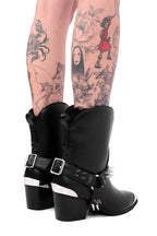 Women's black cowboy boots with silver toe caps and spiked straps