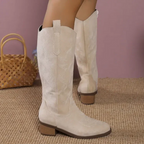 Women's knee-high boots with stitched western motifs, pointed toes and low block heels