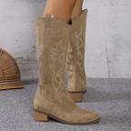Women's knee-high boots with stitched western motifs, pointed toes and low block heels